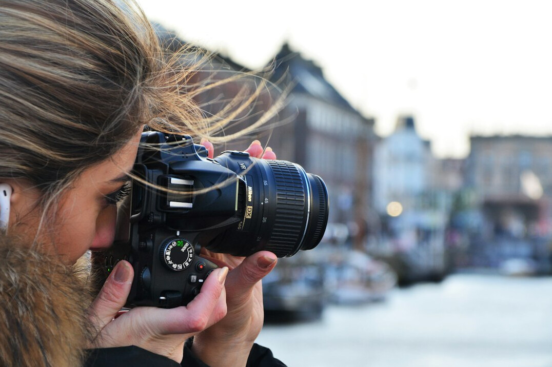Photographers and press capturing a celebrity arriving at a red carpet event in Copenhagen